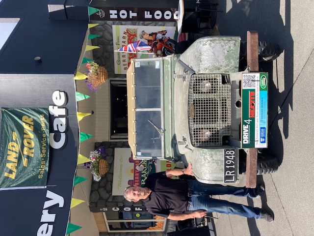 The Drive 4 Hearts Land Rover under the Bakery Cafe sign and bunting